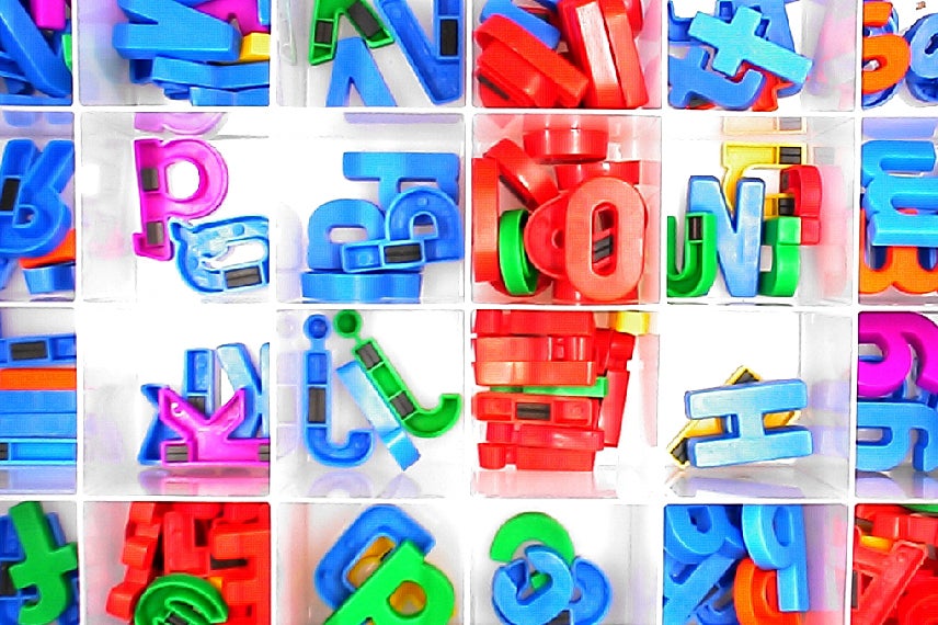 Plastic, magnetic letters in compartmented boxes.