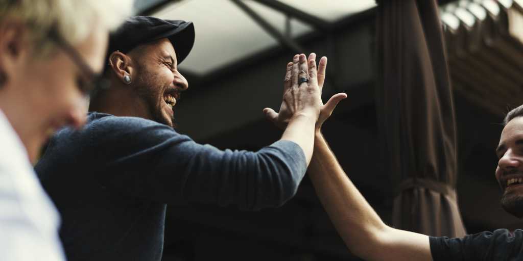 high five; two team members giving high fives