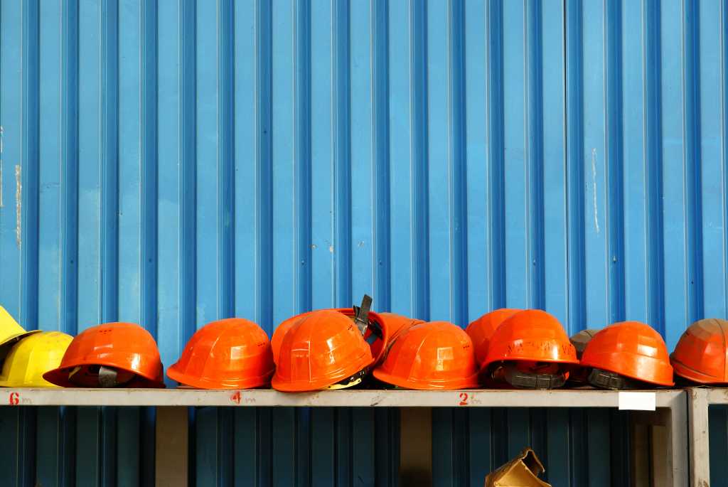 Orange hard hats on a blue background.